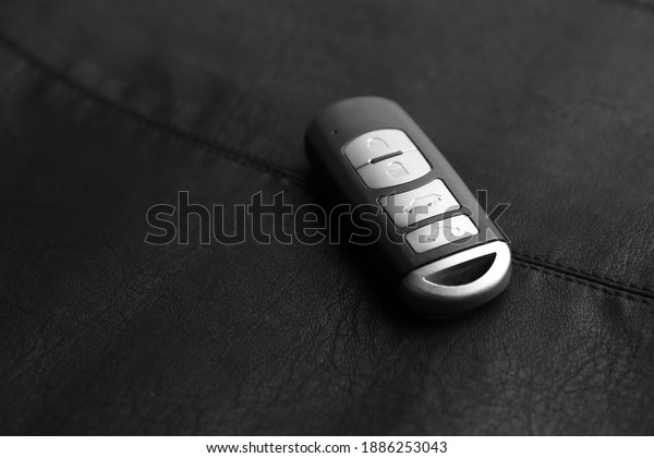 Modern car smart key on leather background. Space\
for text