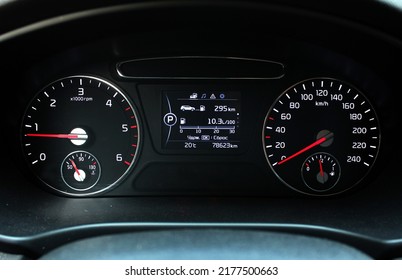 Modern Car Speedometer And Odometer With Light Illuminated. Close Up View Of Tachometer And Dashboard. 