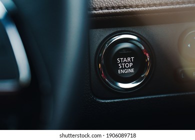 Modern car start and stop engine button - closeup of modern dashboard of modern day car, technology and safety power button.