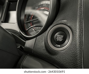 Modern car start and stop engine button - closeup of modern dashboard of modern day car, technology and safety power button. Engine Start Stop button on modern car. Black leather textured dashboard. 