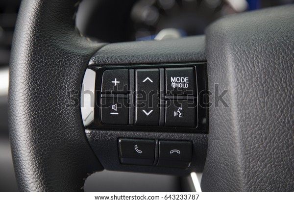 Modern car steering wheel with media control\
buttons car interior\
details