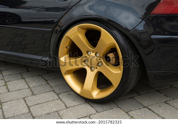 Modern\
car wheel with a light alloy disc. Low\
chassis.