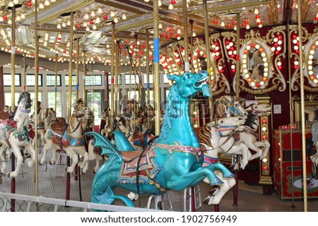 The modern carousel at the Roger Williams park in Providence, Rhode Island. The enclosed joy ride has a blue dragon that's front and center. He's surrounded by gorgeous, trotting, carved horses. Stock photo © 