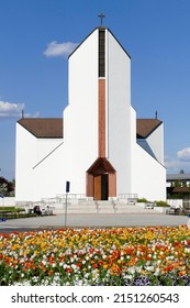 Modern Catholic Church With Hundreds Of Tulips In Tiszaujvaros, Eastern Hungary