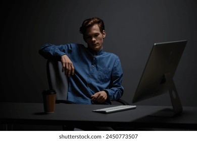 Modern Caucasian businessman typing on laptop at home office: A portrait of a young, confident professional working late night in a stylishly lit room. - Powered by Shutterstock