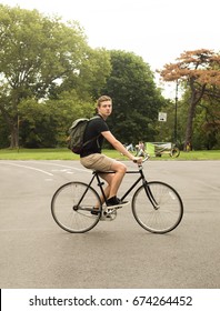 Modern Caucasian College Student Riding Bike In The Park, Photographed In Brooklyn, NY In July 2017