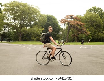 Modern Caucasian College Student Riding Bike In The Park, Photographed In Brooklyn, NY In July 2017