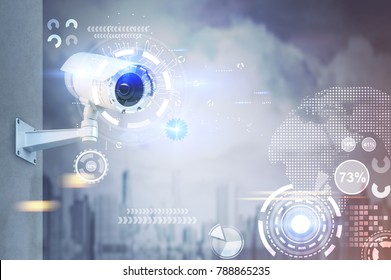 Modern CCTV camera on a wall. A foggy day in a city background with abstract infographics and HUD. Toned image double exposure mock up - Shutterstock ID 788865235