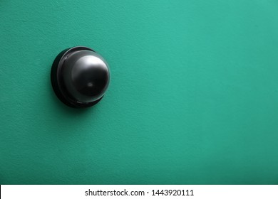 Modern CCTV security camera on green wall. Space for text