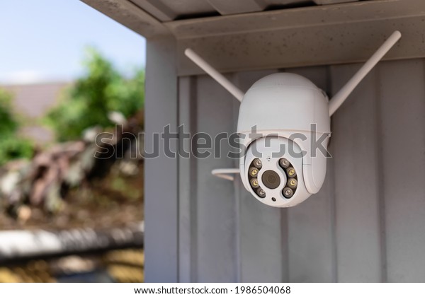 modern CCTV\
wifi surveillance camera installed on the garage for home security\
system. Anti-theft system\
concept.