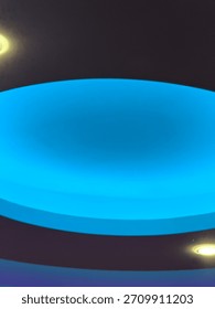 Modern ceiling featuring abstract blue light and dark tones creating a futuristic design