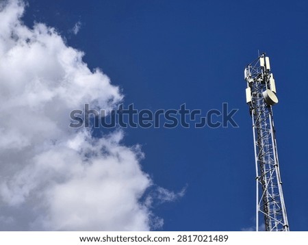 Modern cellular base station supporting wireless communication and mobile connectivity under a clear blue sky with large copy space for technology concepts.