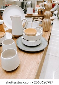 Modern ceramic tableware displayed in a store setting with elegant design elements