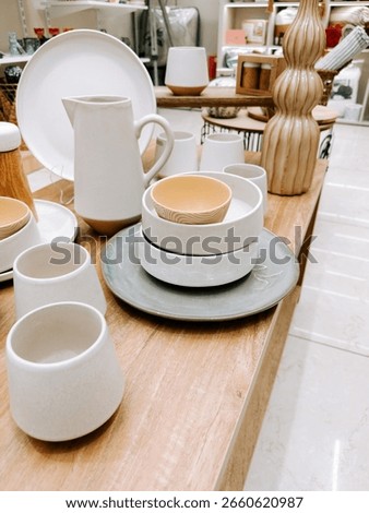 Modern ceramic tableware displayed in a store setting with elegant design elements