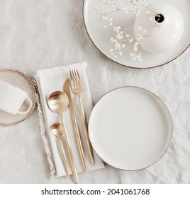 Modern ceramic tableware top view on white linen tablecloth with copy space.  Trendy plates, cutlery and linen napkins scandinavian style.Space for text or menu . Business food brand template.