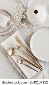 Modern ceramic tableware top view on white linen tablecloth with copy space.  Trendy plates, cutlery and linen napkins scandinavian style.Space for text or menu . Business food brand template.