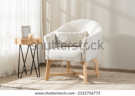 modern chair in a cozy corner of a room, next to a round table, creating a warm and inviting atmosphere