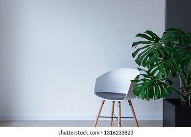 Modern chair near light wall - Shutterstock ID 1316233823