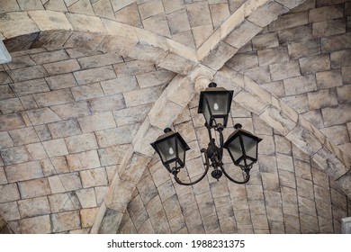 Modern Chandelier Light Hung From The Ceiling Of A Brick Barrel Vault (self-supporting Arched Structure).