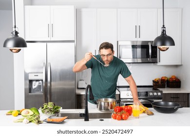 modern chef in professional uniform. close-up on the hand of male chef who is stirring soup in pot with spoon. cooking, culinary and people concept - male chef in toque with pot or saucepan. - Powered by Shutterstock