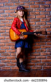 Modern Child Girl Playing Guitar And Singing A Song. Rock Star, Rock Music, Pop Music Concept.