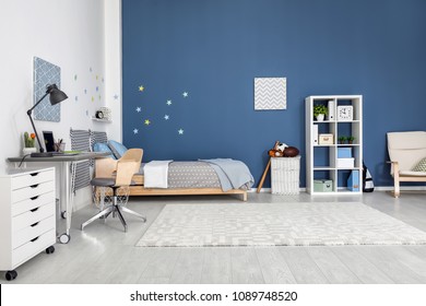 Modern child room interior with comfortable bed and desk