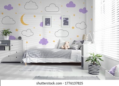 Modern child room interior with comfortable bed near window 