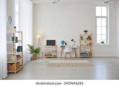 Modern children's room at home. Spacious interior with a desk for studying, a chair, bookshelves, chalkboard, Earth globe, green plants, boxes, toys, and a play area with a rug, and laminate flooring - Powered by Shutterstock