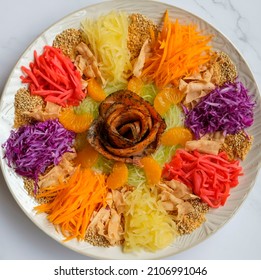 Modern Chinese fish salad. Yusheng aka Prosperity Toss. Mixed variety of vegetables with vibrant colors and  blend of smoked salmon slices to enhanced the taste.