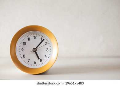 Modern Circular Alarm Clock On White Wood Table Background And Tell Time In Morning Or Evening With Copy Space, Home Decoration, Time To Wake Up