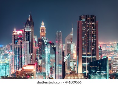 Modern City Architecture By Night. Business Bay, Dubai, United Arab Emirates. Colorful Nighttime Skyline. 