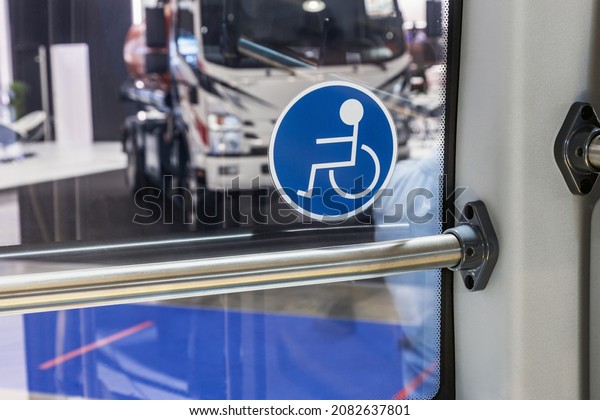modern city bus with seats for disabled and\
elderly people. sticker on the bus\
window