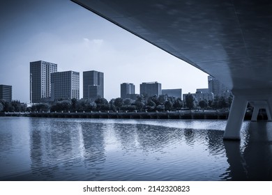 Modern City By The River And Bridge