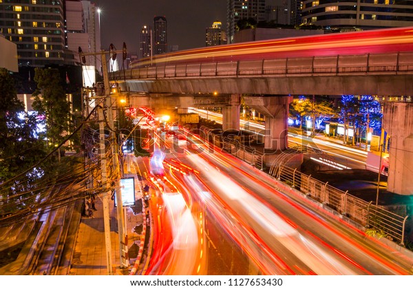 Modern city with car\
light line at night.