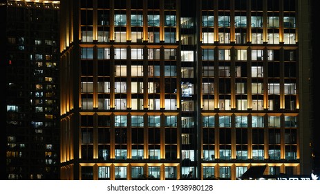 The Modern City Night View Full Of The Light Window In The Skyscrapers At Night