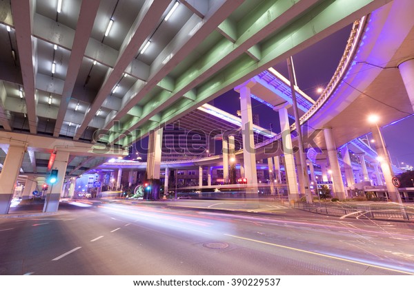 \
Modern city Shanghai, under the overpass at\
night car light trails