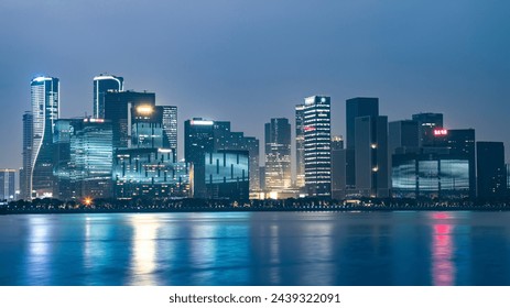 Modern City Skyline Reflecting on Water at Night - Powered by Shutterstock