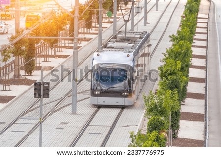 Modern city tram. Public transport in aerial top view