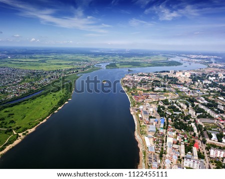 Modern city view. Town on river. Tomsk cityscape and Tom river from aerial view. Modern architecture. Beautiful sky. City downtown. Water resources. Siberia, Russia