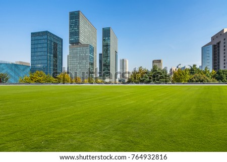 modern cityscape and skyline  from meadow in park