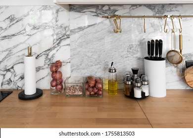 Modern classic kitchen interior with kitchen appliances and raw ingredients on wood top with marble wall in the background / kitchen interior - Powered by Shutterstock