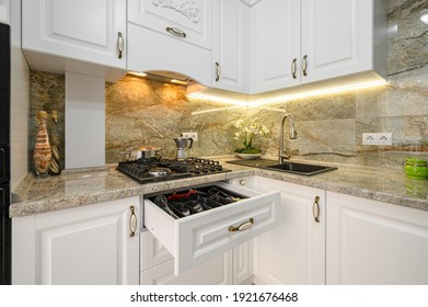 Modern classic luxury white kitchen with wooden furniture, upper drawer is pulled out