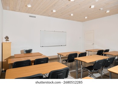 The modern classroom setup features a spacious layout with desks and a large whiteboard