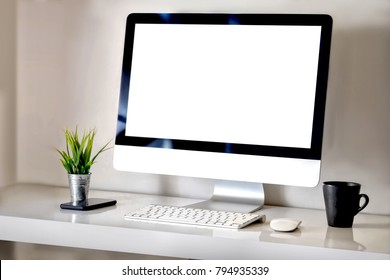 Modern clean workspace mockup with blank screen desktop computer and office supplies.