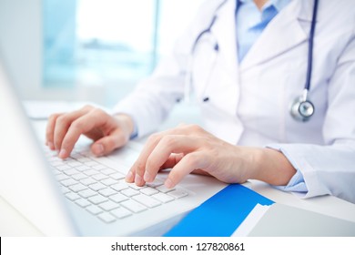 Modern Clinician Inputting Diagnosis Into An Online Data Base