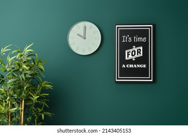 Modern Clock And Picture Hanging On Color Wall In Room