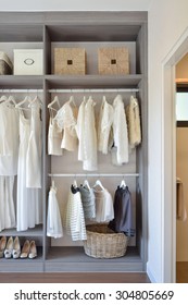 Modern Closet With Row Of White Dress And Shoes Hanging In Wardrobe