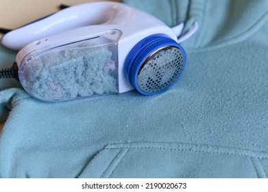 Modern cloth razor with full tank on clothes, space for text. View from above. - Shutterstock ID 2190020673