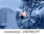 Modern CNC milling machine during operation. Produced cutting metal parts, industry heavy factory.