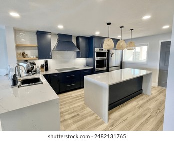 Modern coastal condo kitchen with blue cabinets, White Island, and wood accents. - Powered by Shutterstock